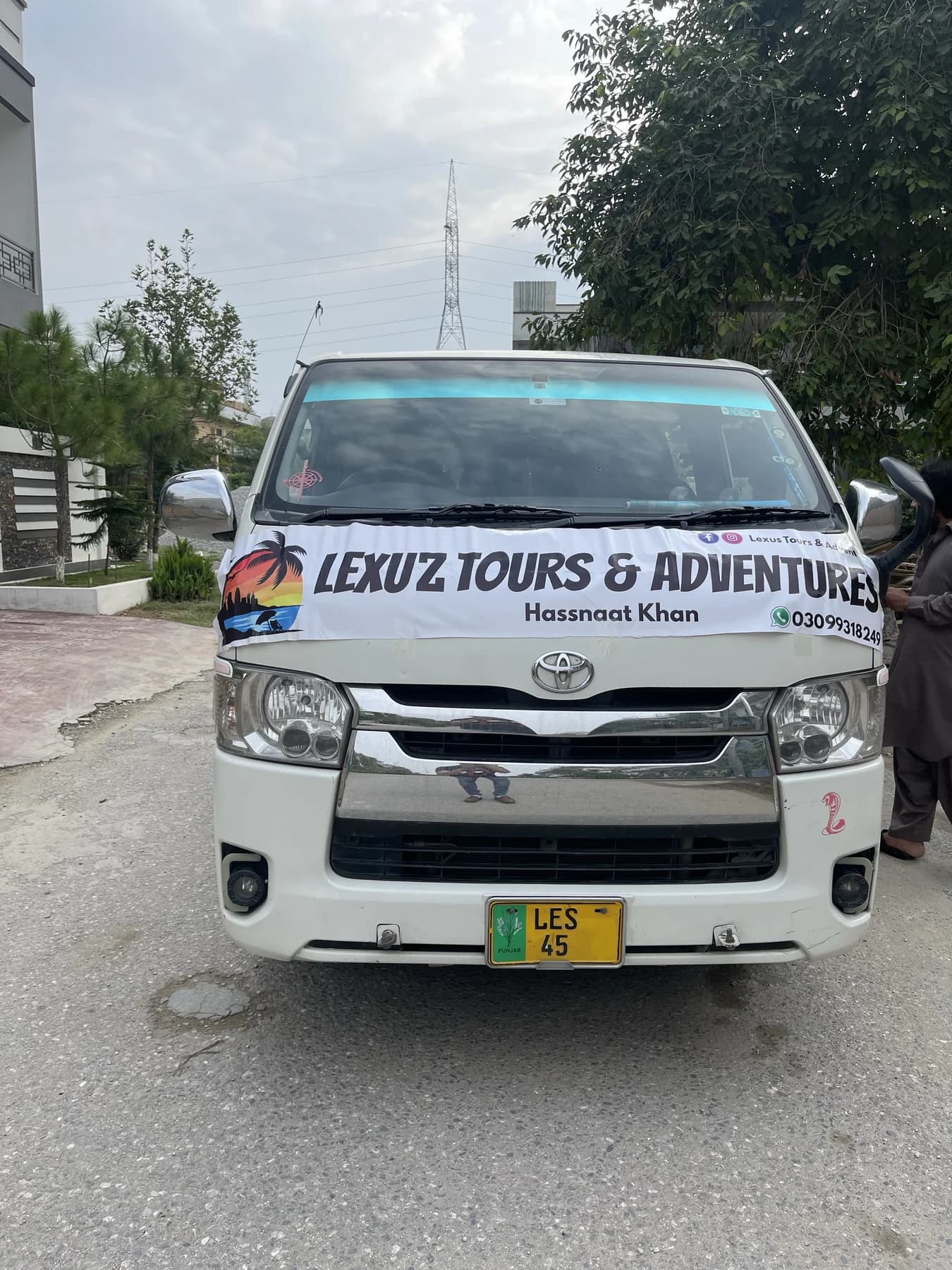 Front view of a branded Lexuz Tours coaster