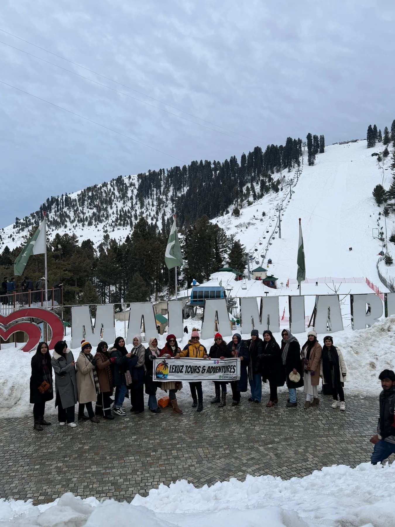 Lexuz Tours group gathered in snowy mountain scenery